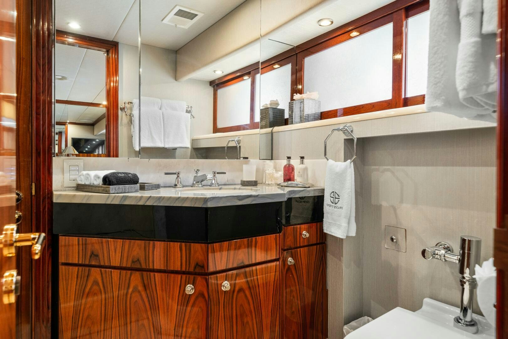 a bathroom with a sink and a mirror aboard SWEET ESCAPE Yacht for Sale