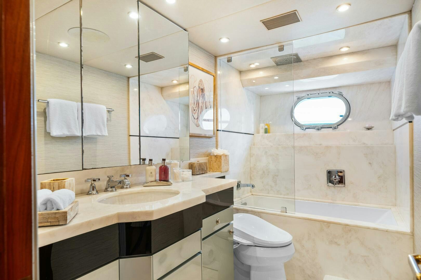 a bathroom with a large mirror aboard SWEET ESCAPE Yacht for Sale