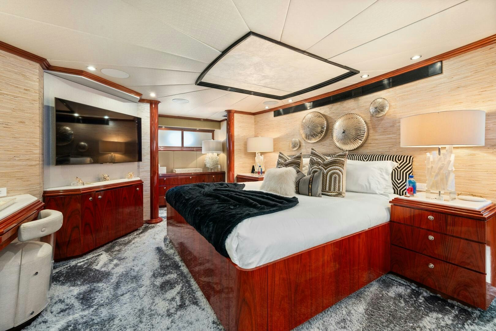 a room with a bed and a dresser aboard SWEET ESCAPE Yacht for Sale