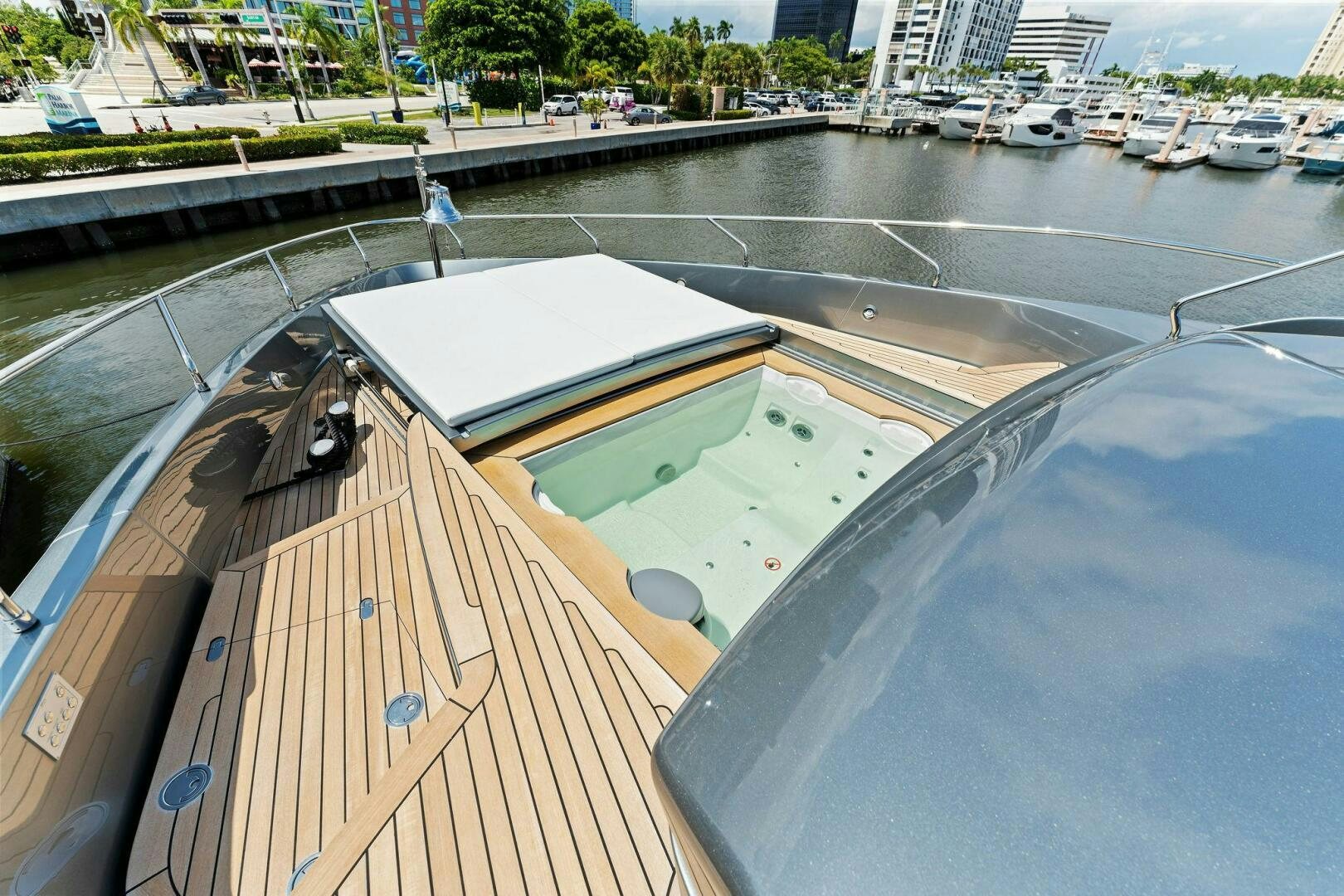 a deck with a pool and a building in the background aboard RIVA 110/29 Yacht for Sale