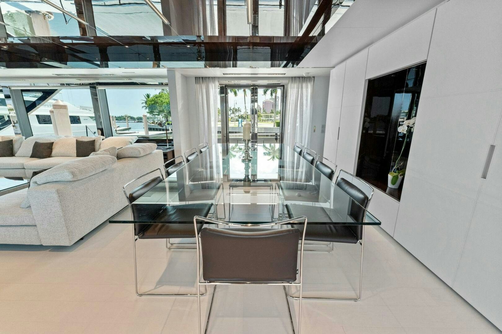 a room with a table and chairs aboard RIVA 110/29 Yacht for Sale