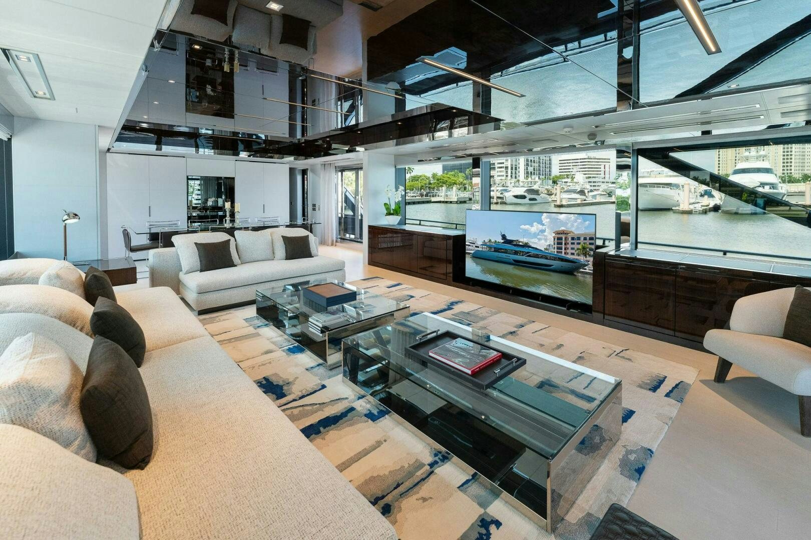 a living room with a large screen aboard RIVA 110/29 Yacht for Sale