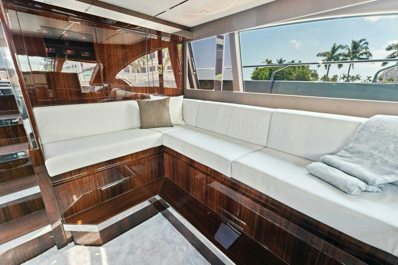 a room with a couch and a window aboard RIVA 110/29 Yacht for Sale