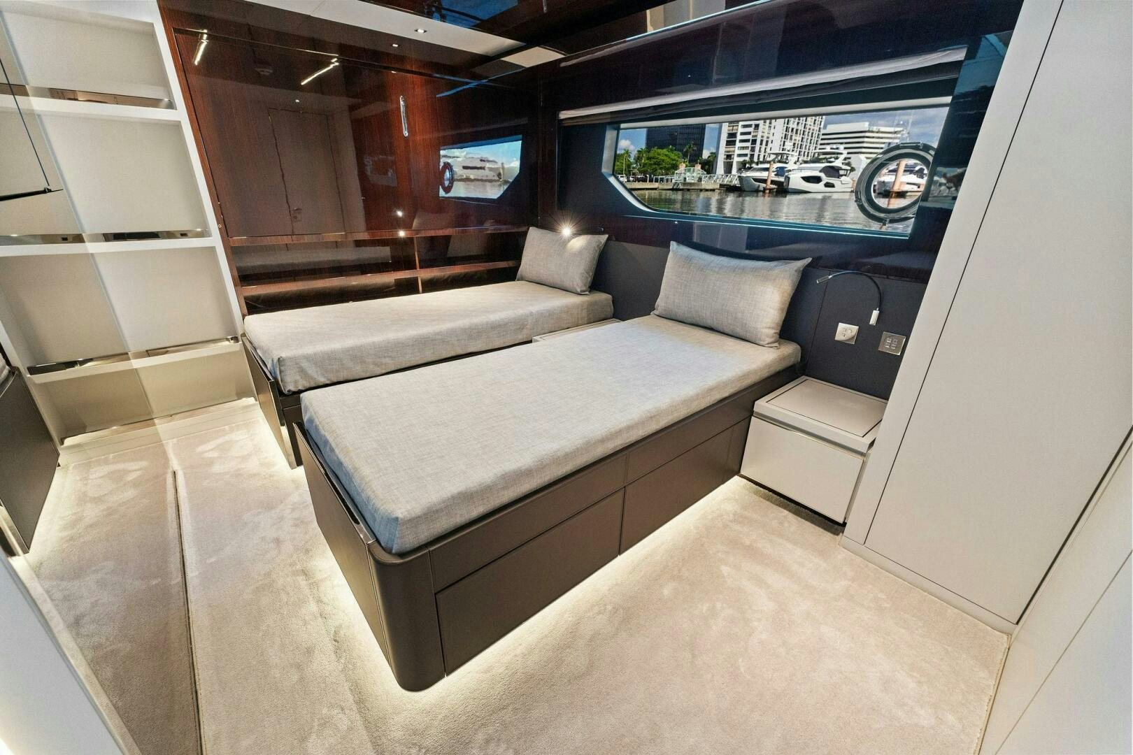 a room with a couch and a window aboard RIVA 110/29 Yacht for Sale