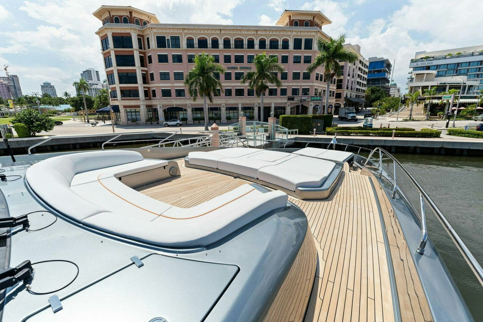 a deck with a pool and a building in the background aboard RIVA 110/29 Yacht for Sale