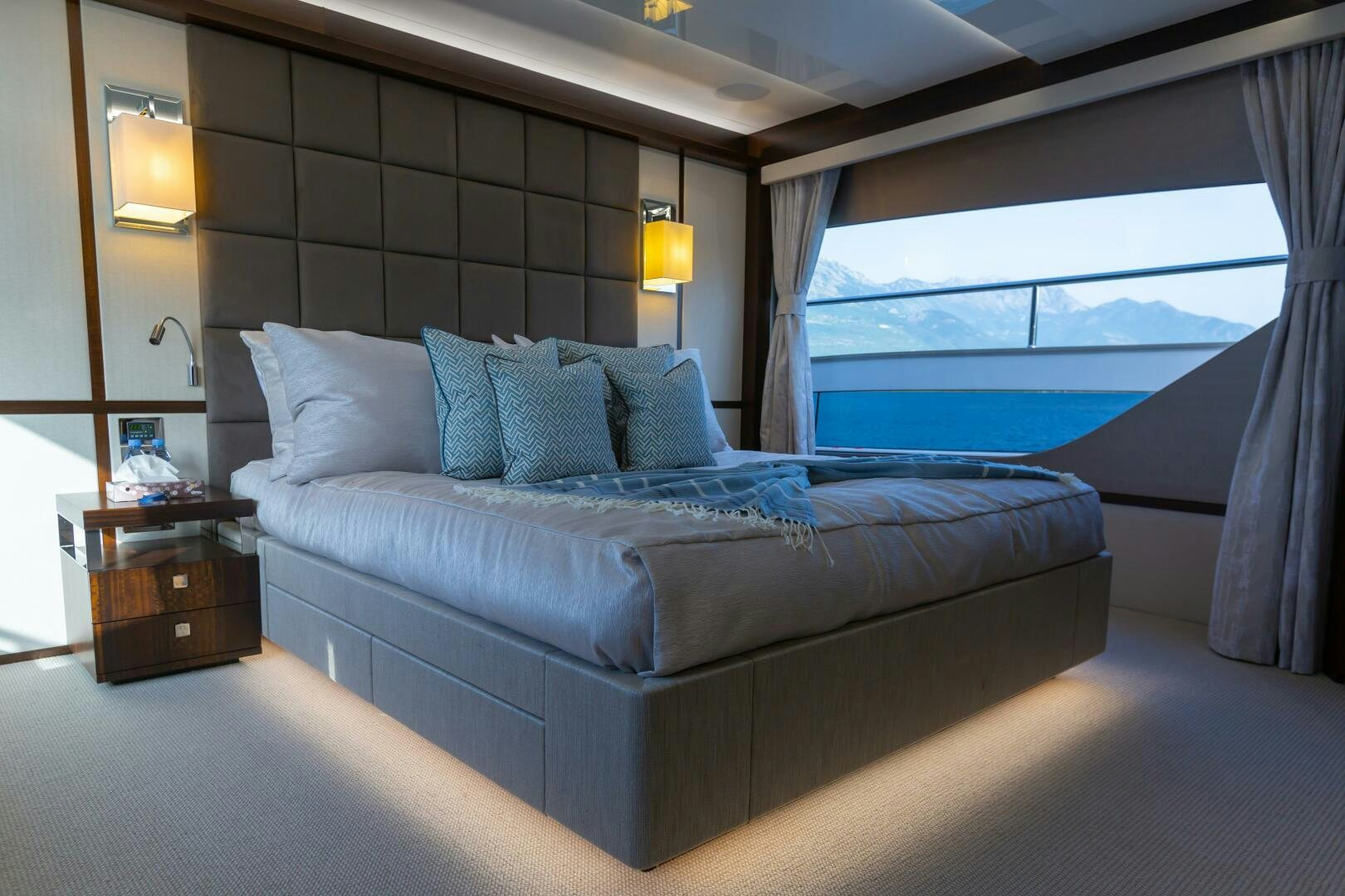 a bed with a blue pillow aboard MR. K IRISTON Yacht for Sale