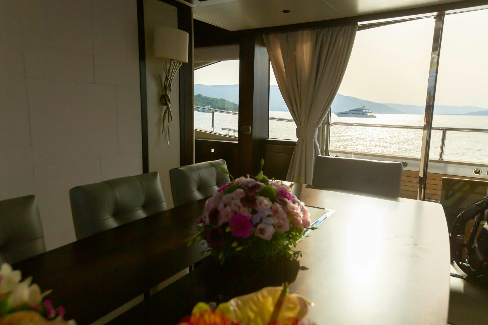 a table with flowers on it aboard MR. K IRISTON Yacht for Sale