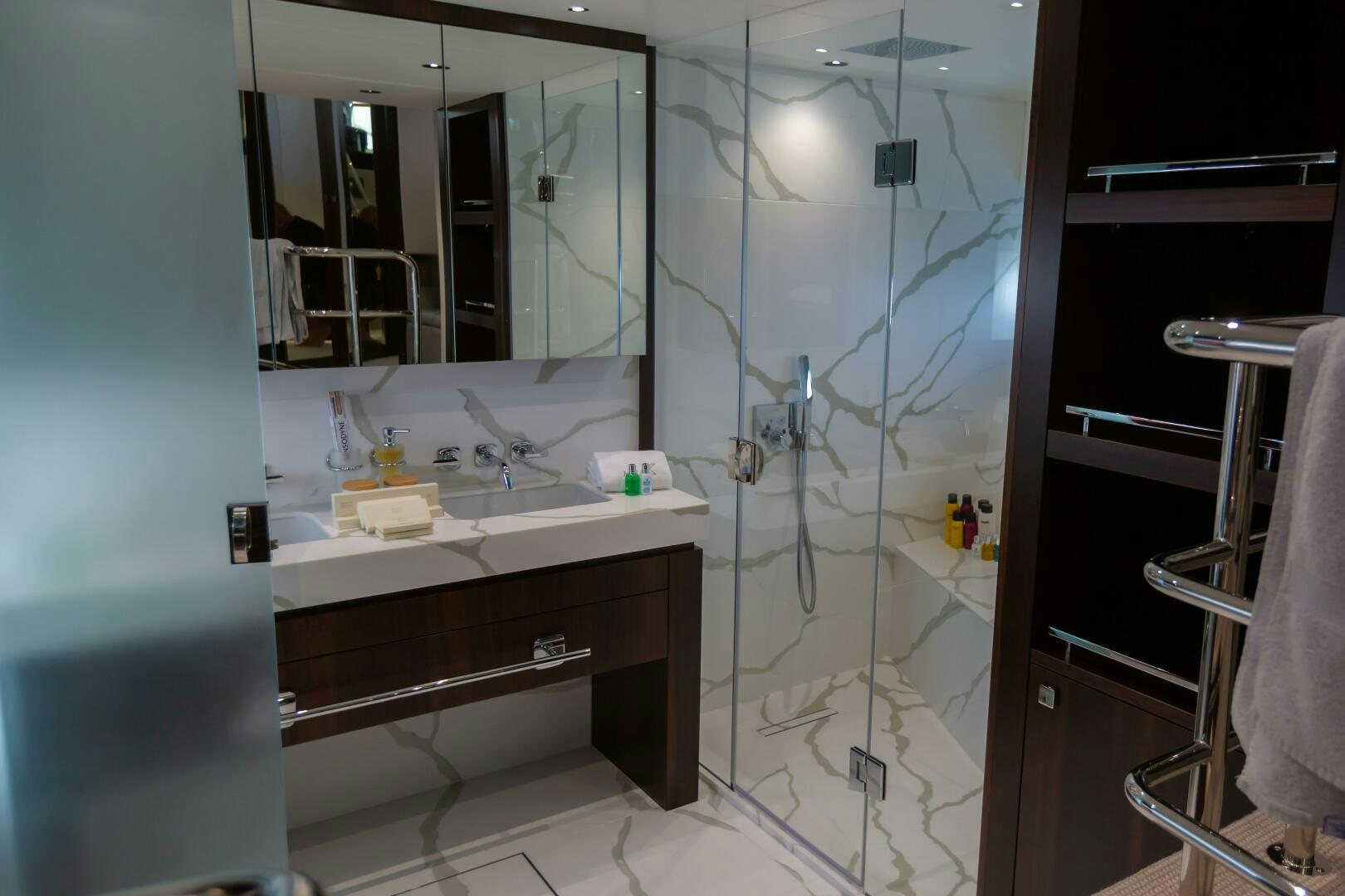 a bathroom with a glass shower aboard MR. K IRISTON Yacht for Sale
