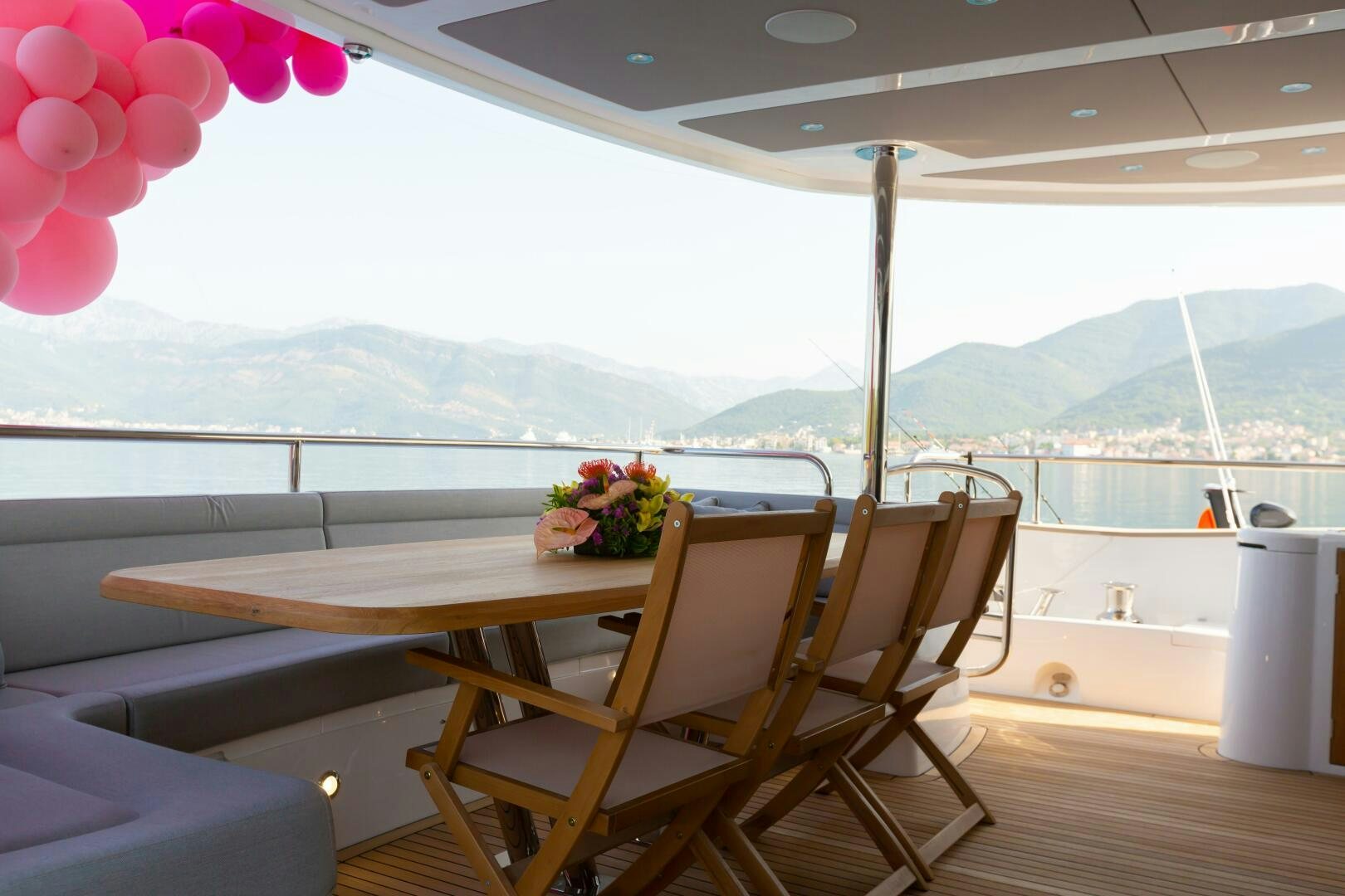 a table with flowers on it aboard MR. K IRISTON Yacht for Sale