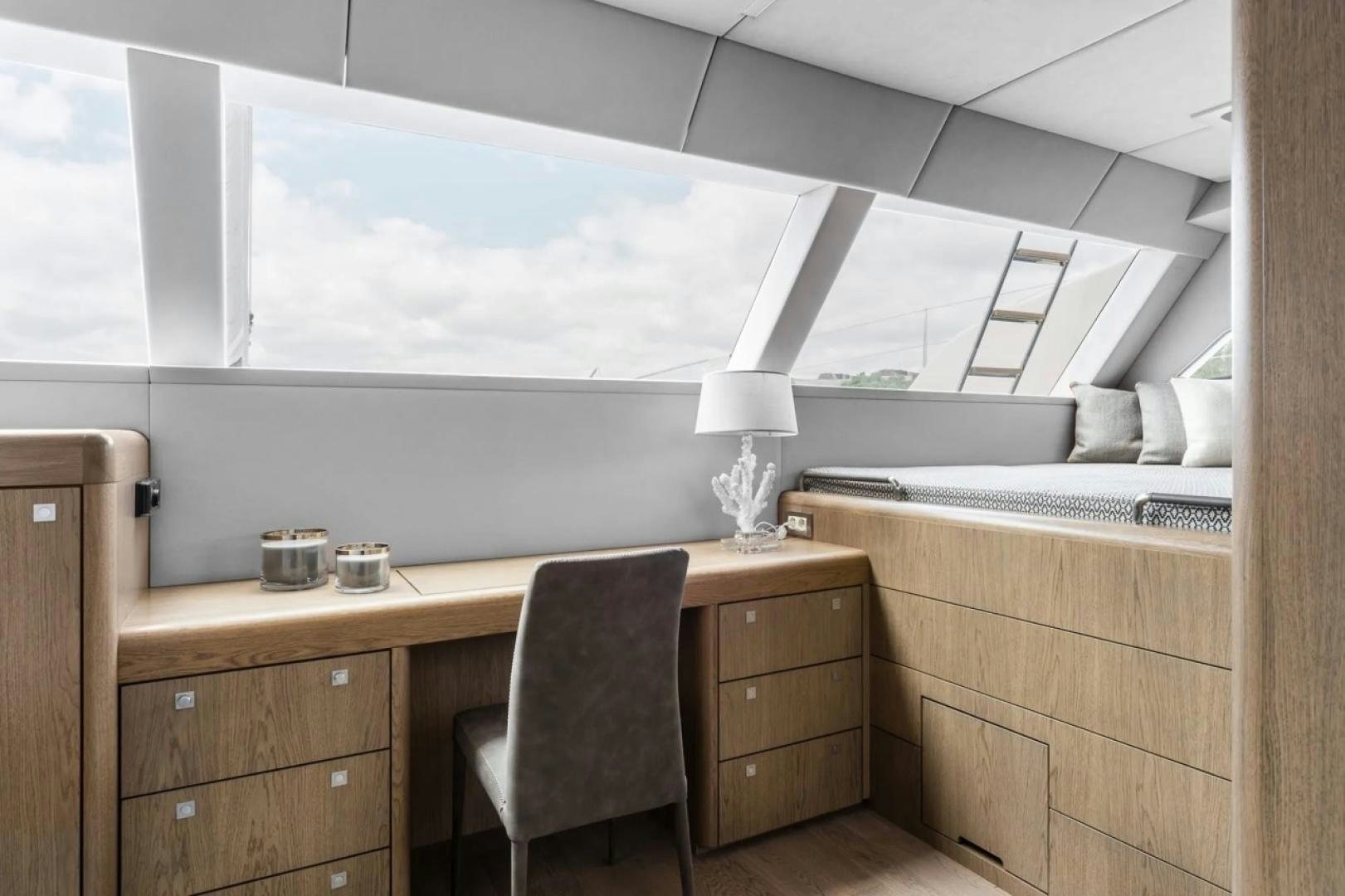a room with a desk and a window aboard LITTLE GIANT Yacht for Sale