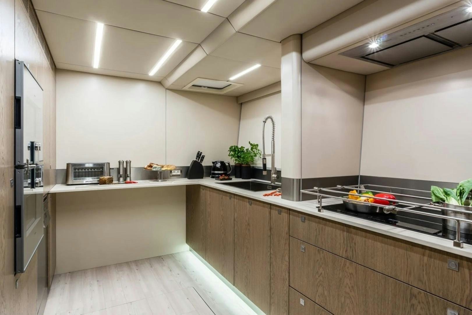 a kitchen with a large island aboard LITTLE GIANT Yacht for Sale