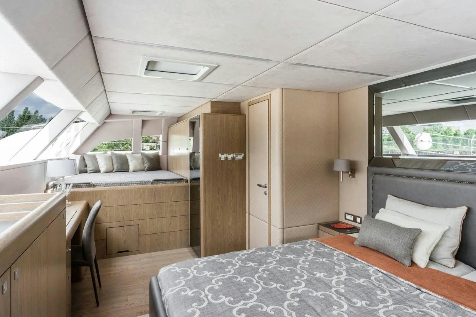 a bedroom with a bed and a desk aboard LITTLE GIANT Yacht for Sale