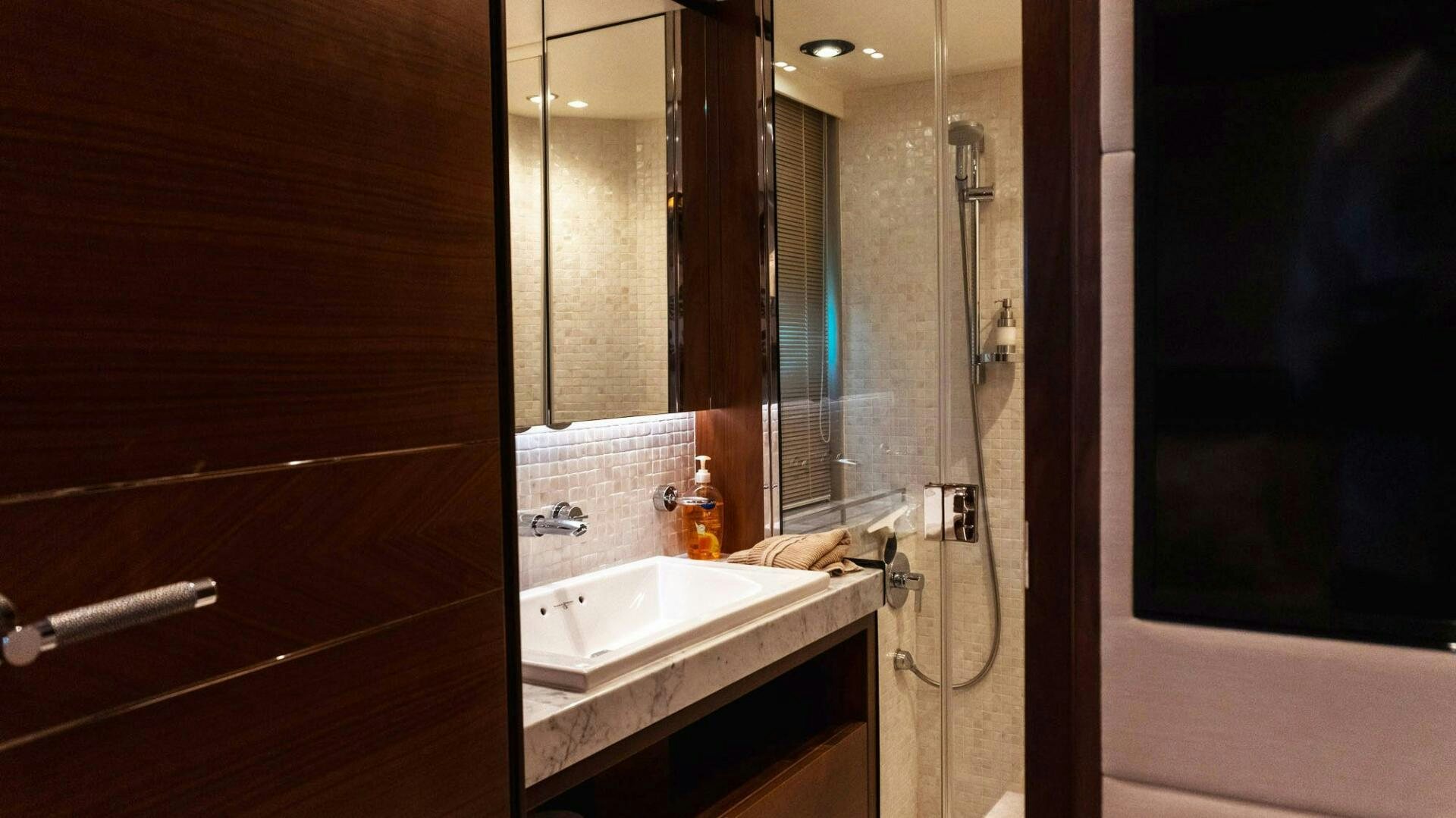 a bathroom with a sink and a mirror aboard SATORI Yacht for Sale