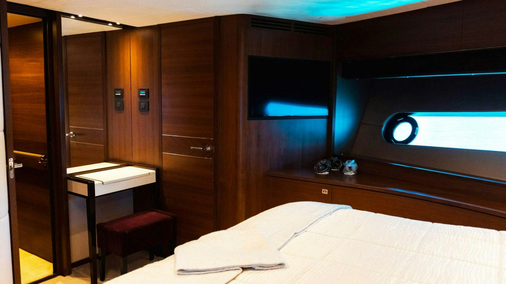 a room with a bed and desk aboard SATORI Yacht for Sale