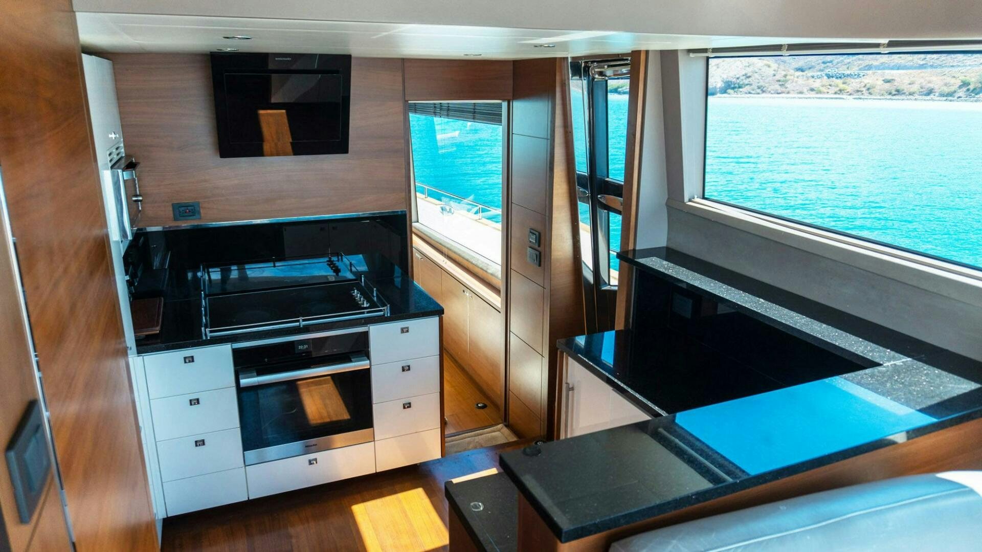 a kitchen with a stove and a window aboard SATORI Yacht for Sale