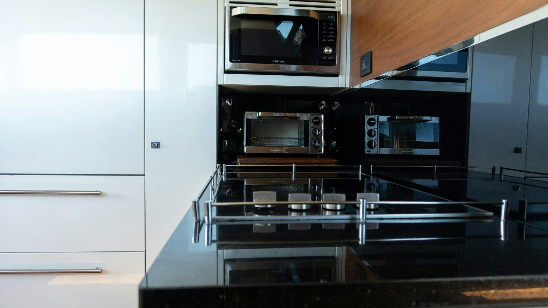 a kitchen with a stove and microwave aboard SATORI Yacht for Sale