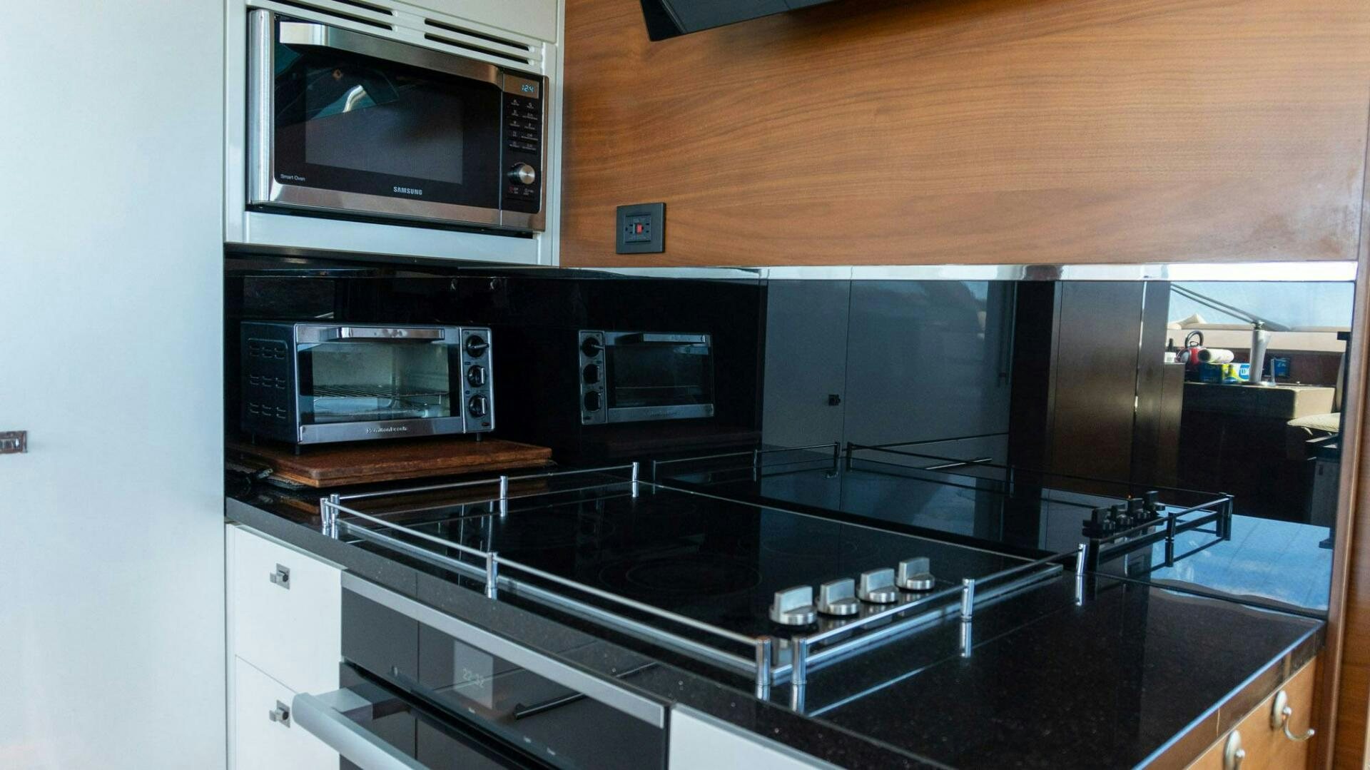 a kitchen with black counter tops aboard SATORI Yacht for Sale