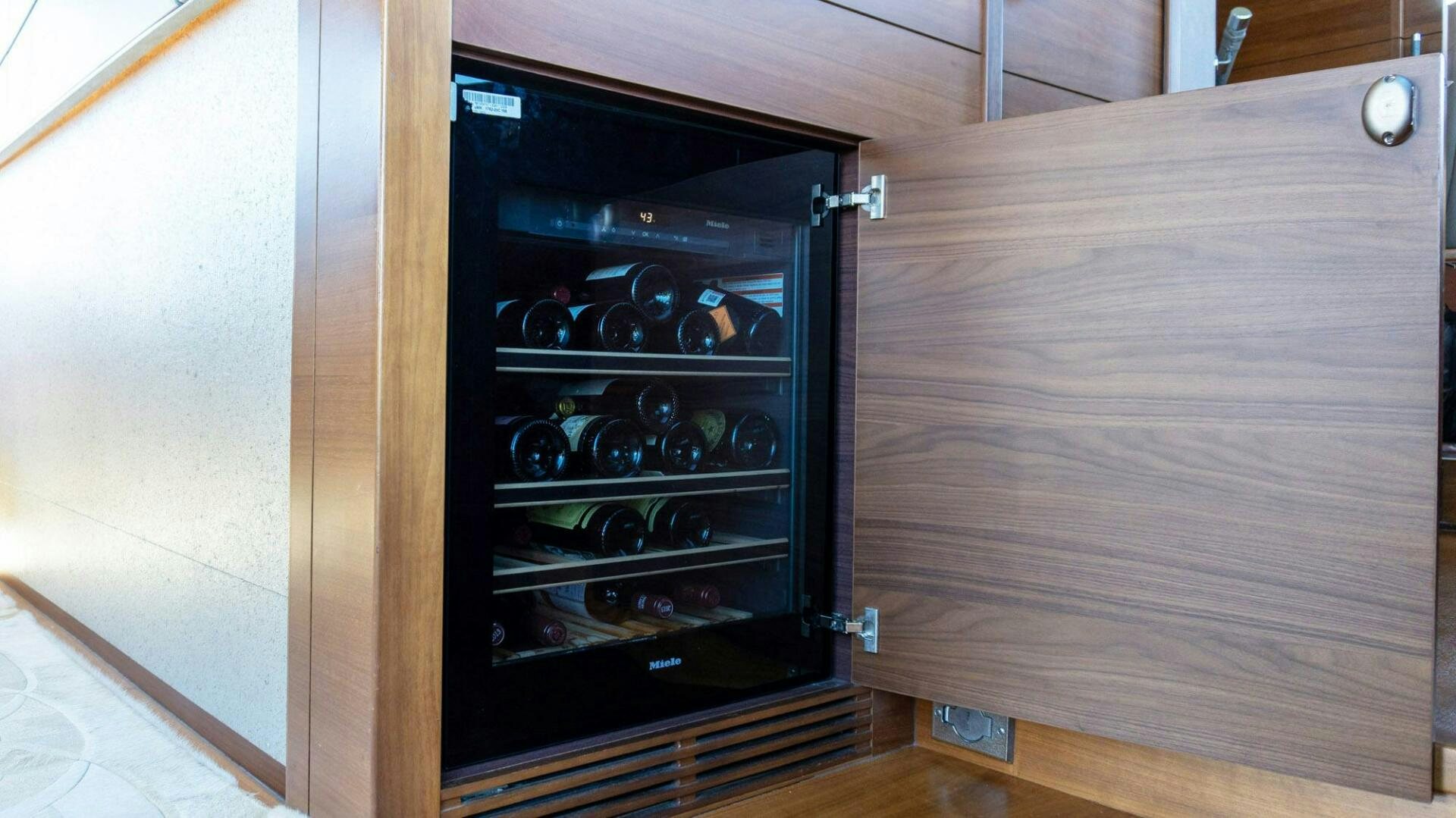 a black cabinet with a glass door aboard SATORI Yacht for Sale