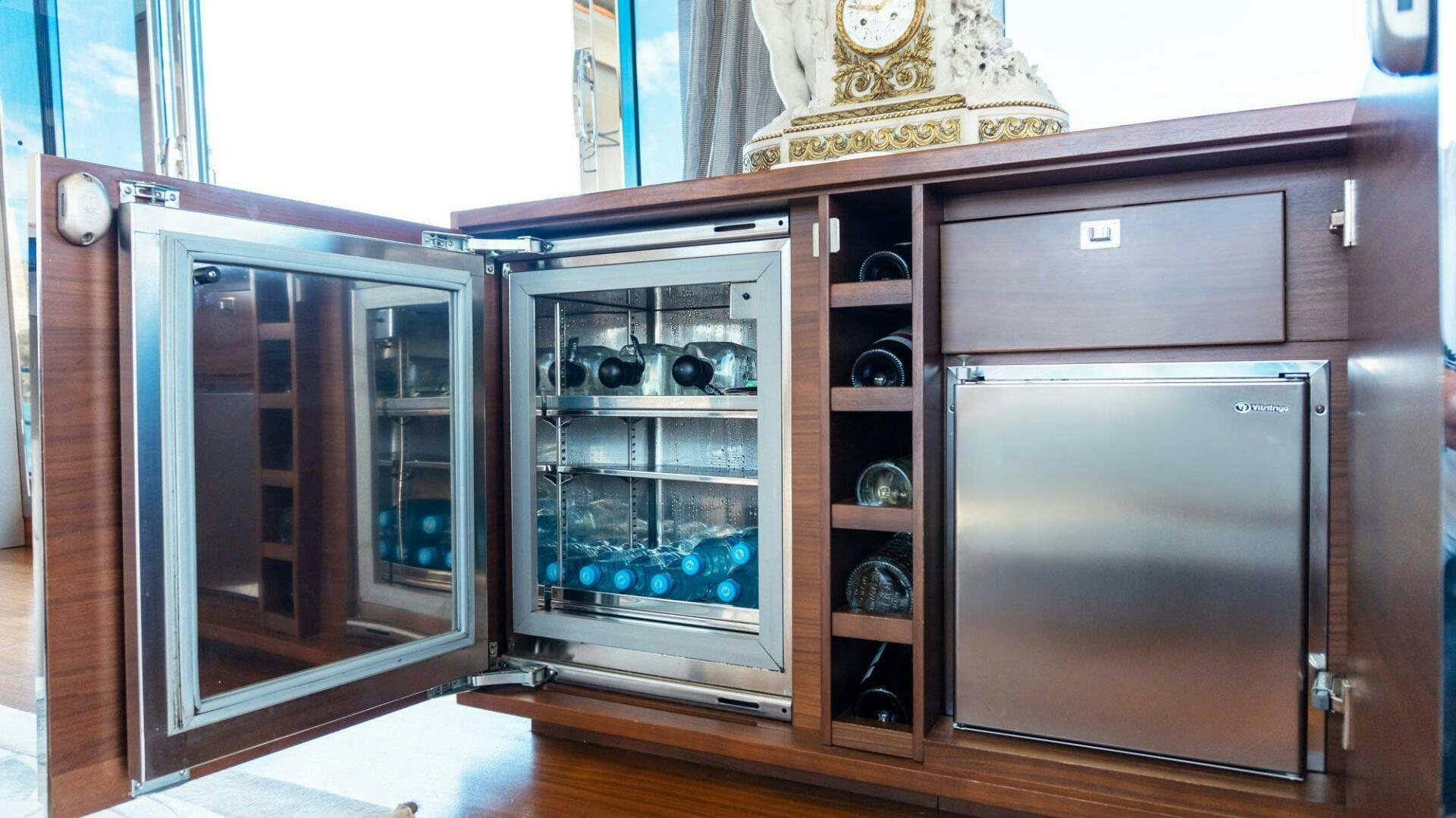 a couple of glass cabinets with a clock on top aboard SATORI Yacht for Sale