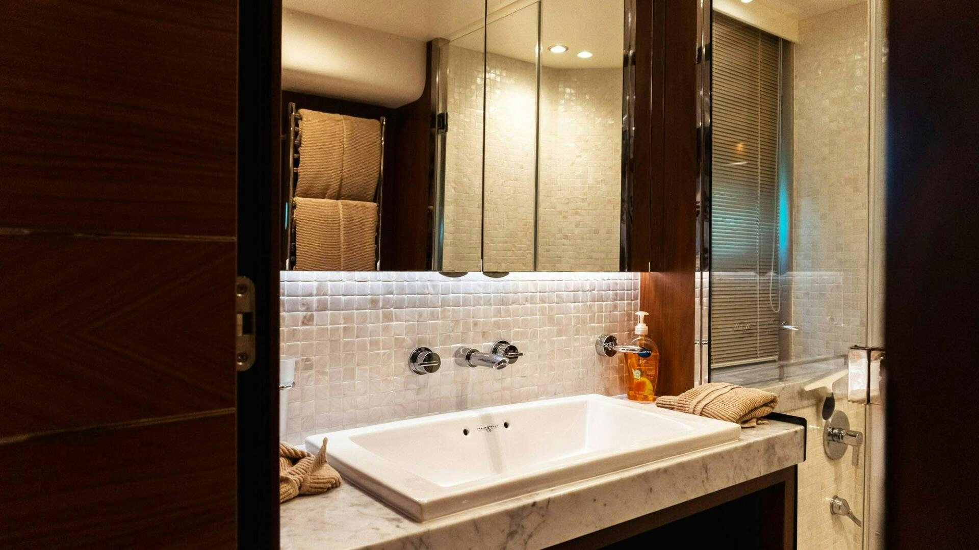 a bathroom with a large mirror aboard SATORI Yacht for Sale