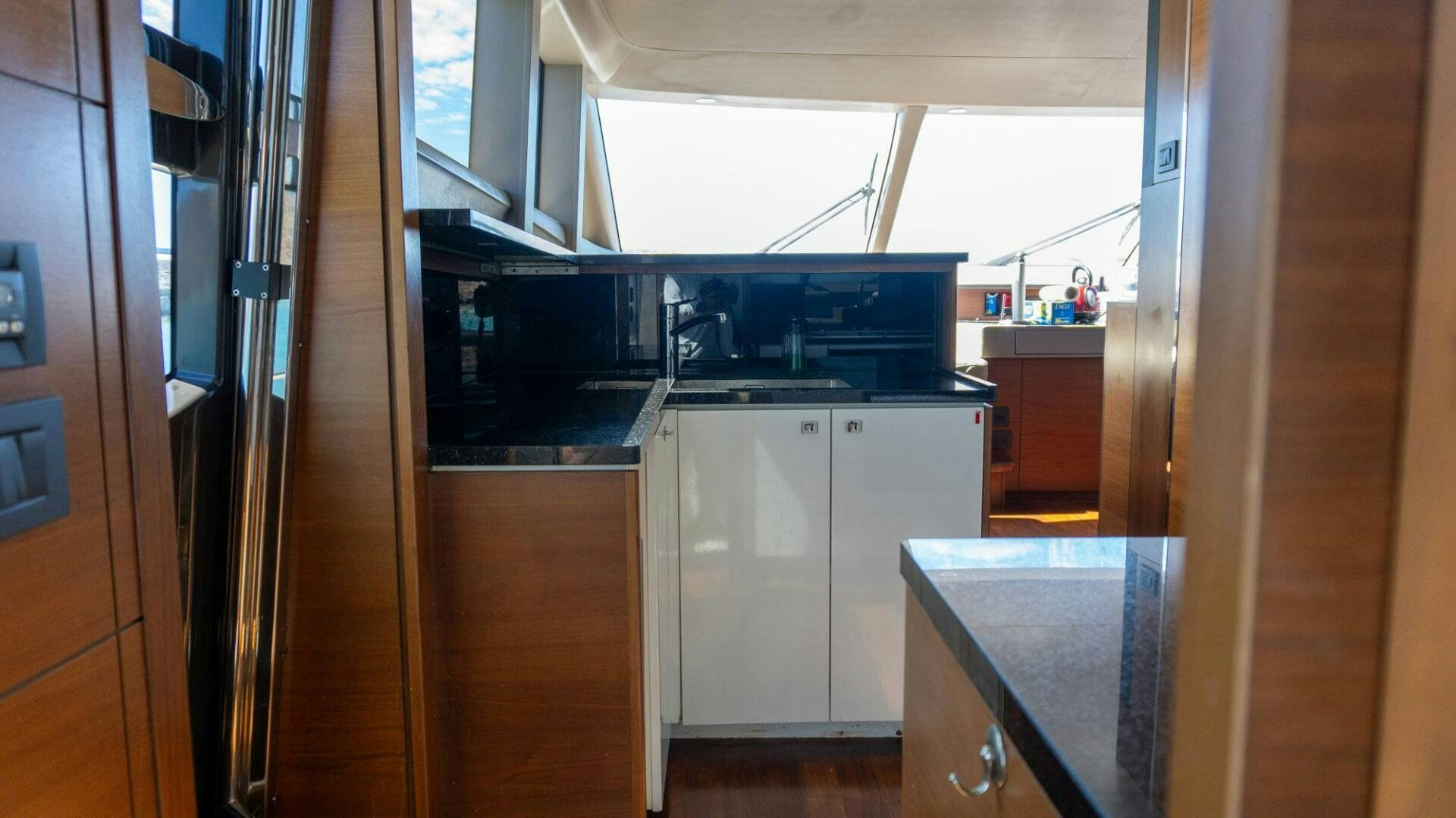a kitchen with white cabinets aboard SATORI Yacht for Sale