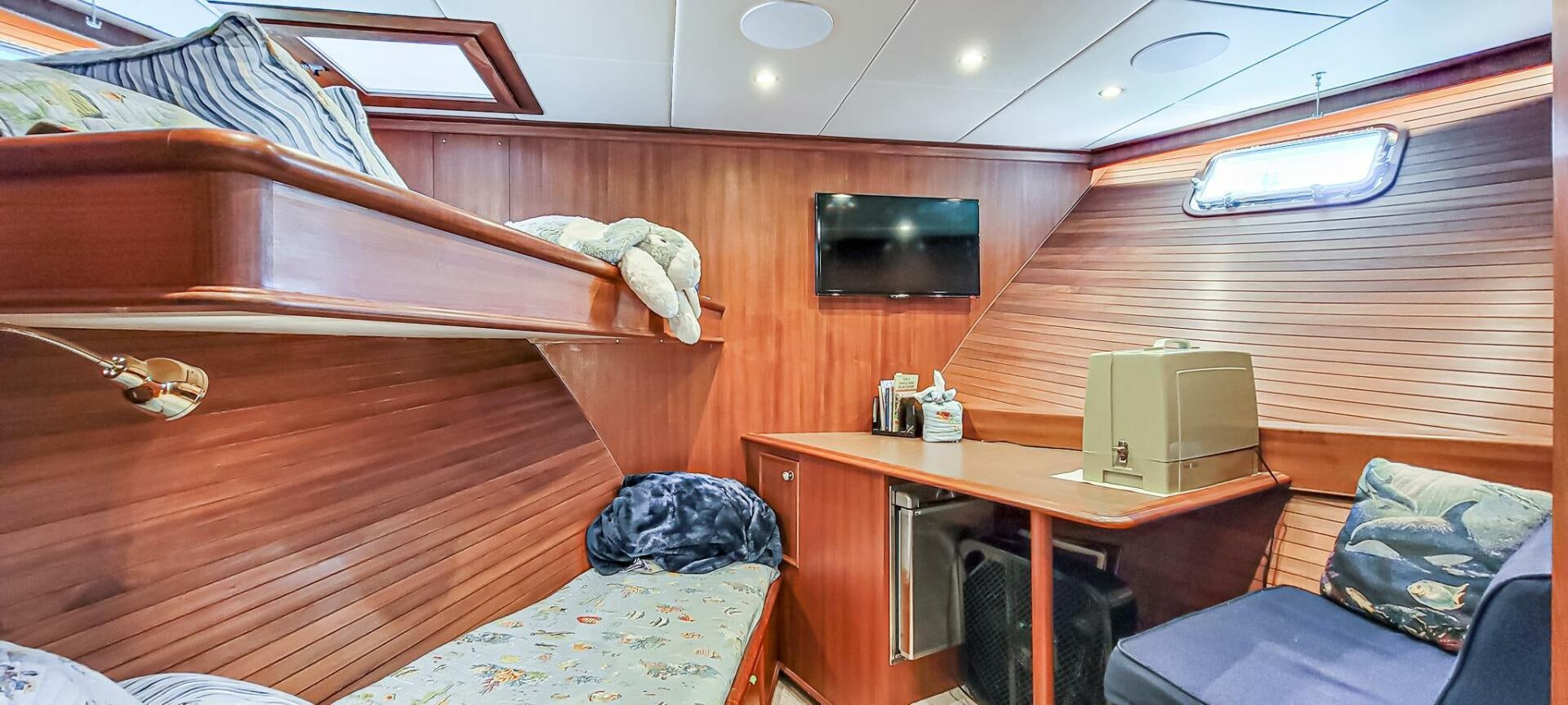 a room with bunk beds and a desk aboard IIWII Yacht for Sale