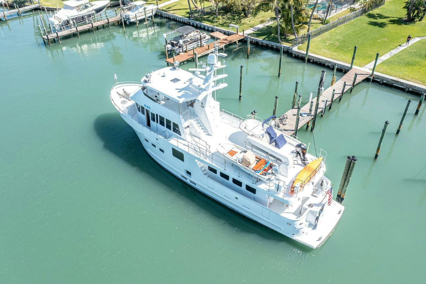 a large white boat docked aboard IIWII Yacht for Sale
