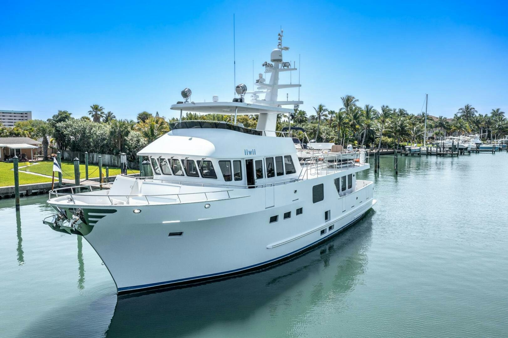 a large white boat in a harbor aboard IIWII Yacht for Sale