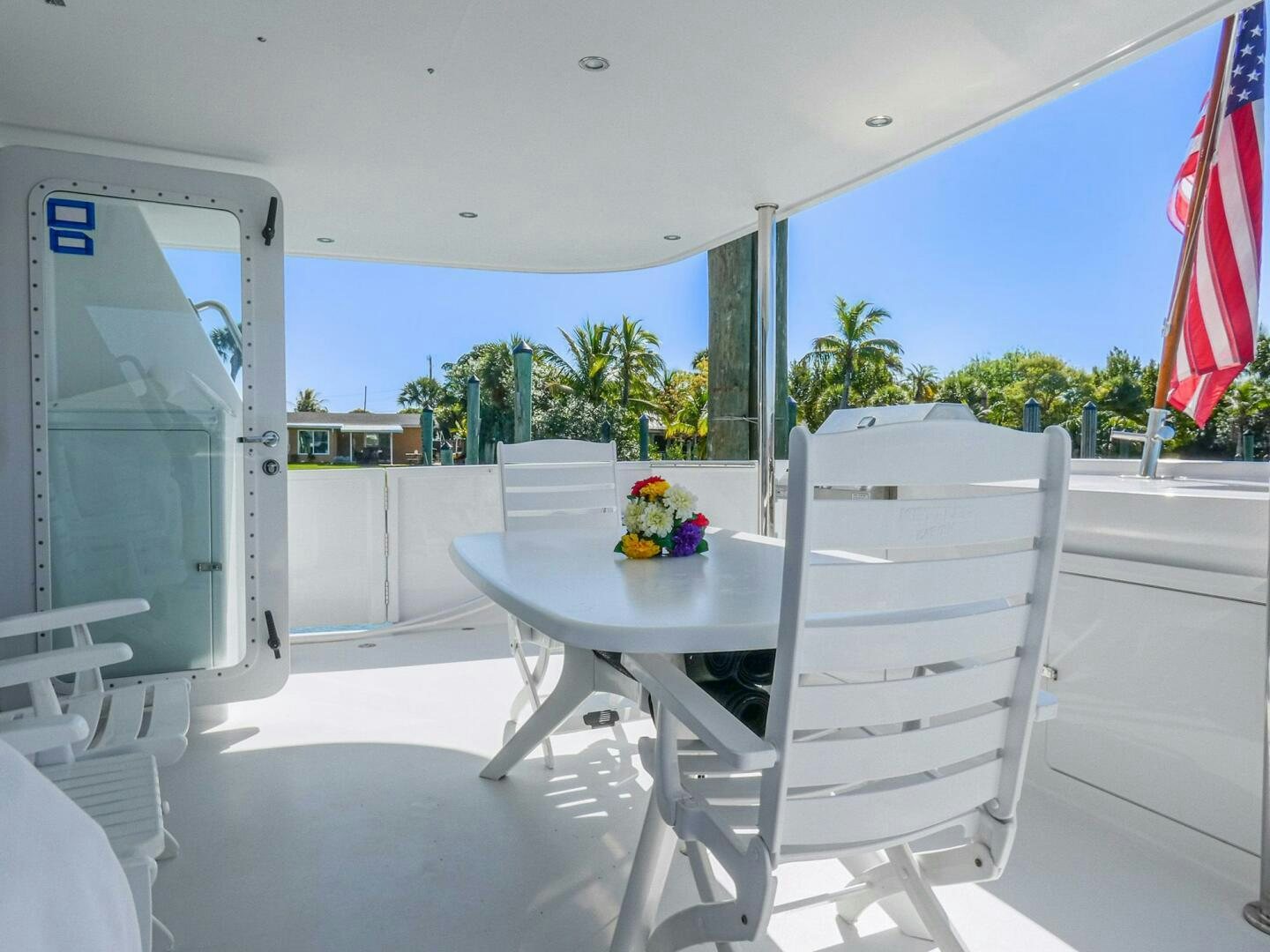a table and chairs outside a building aboard IIWII Yacht for Sale