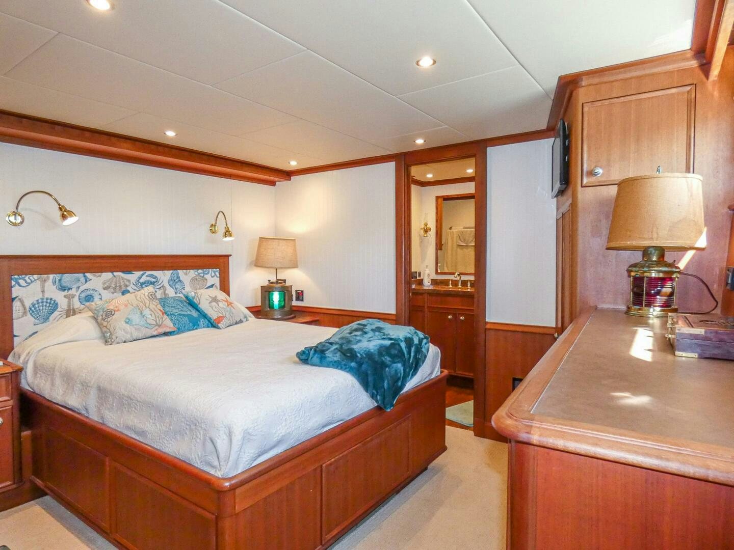 a bedroom with a bed and a desk aboard IIWII Yacht for Sale