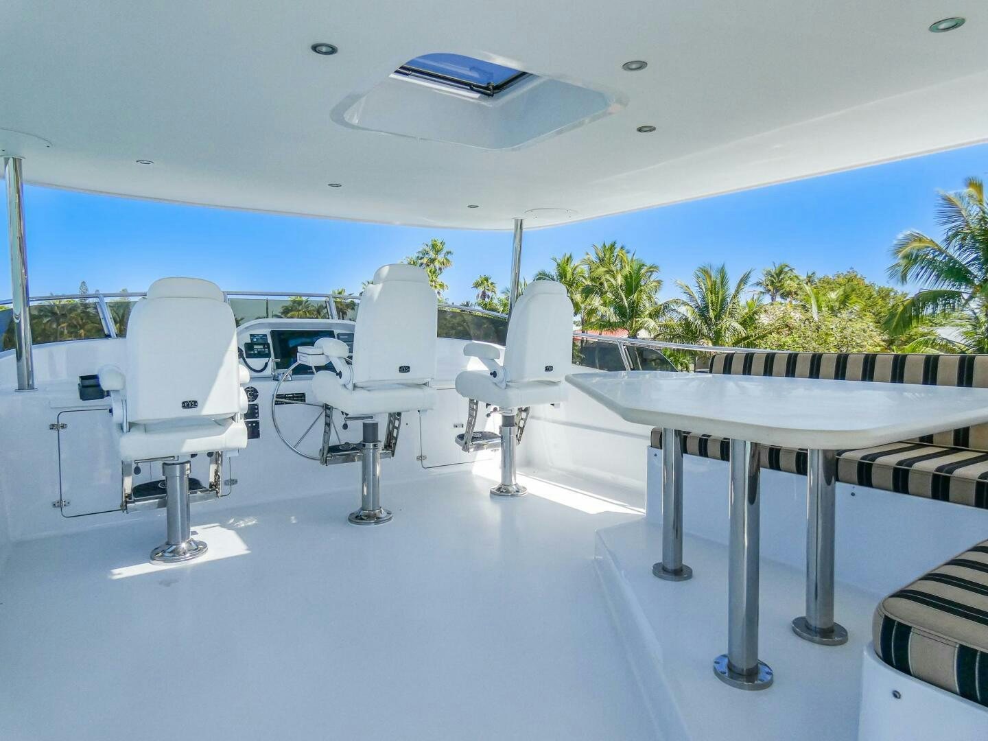 a group of white chairs aboard IIWII Yacht for Sale