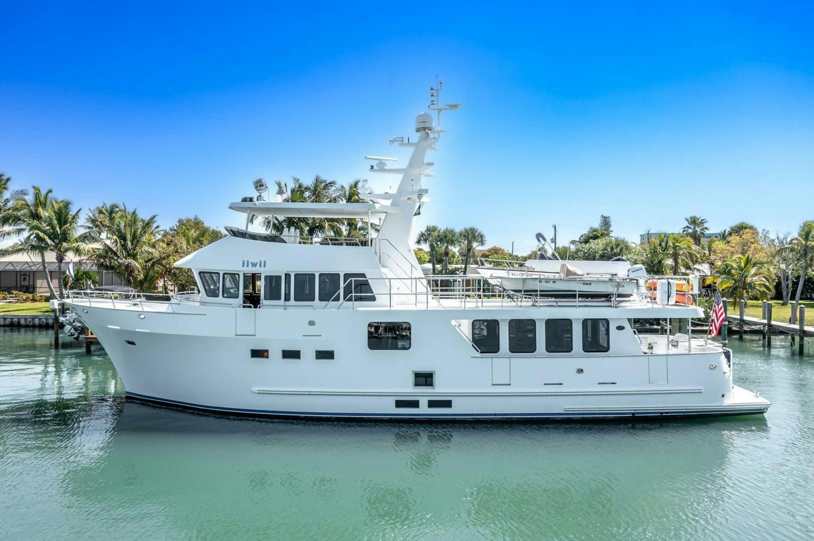 a white boat in the water aboard IIWII Yacht for Sale