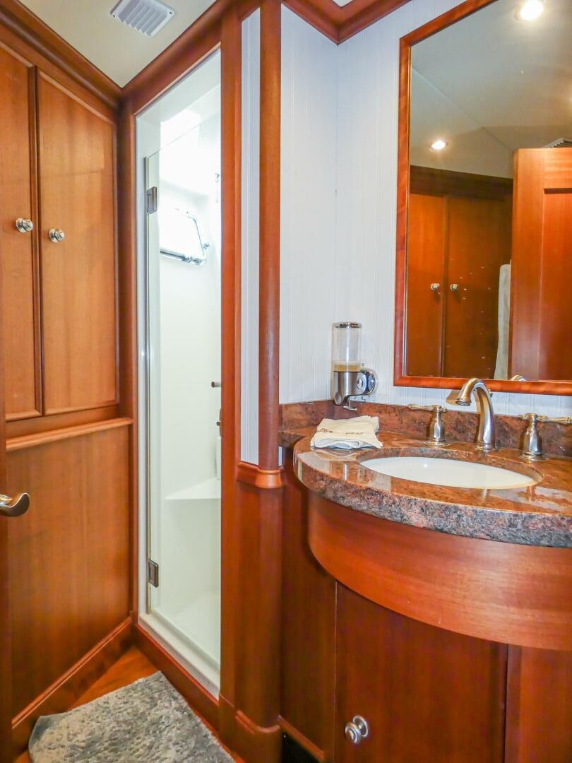 a bathroom with a sink and a mirror aboard IIWII Yacht for Sale