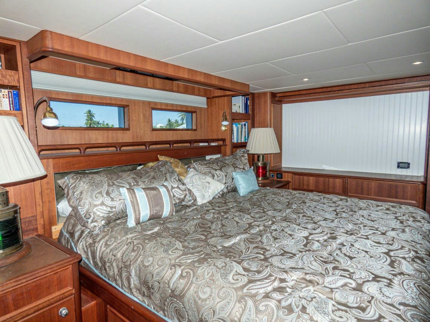 a bed with a large headboard aboard IIWII Yacht for Sale