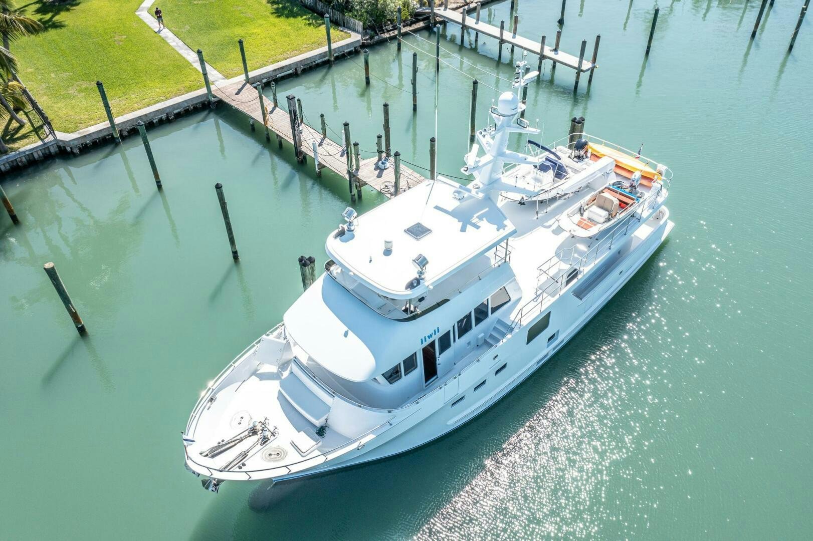 a large white boat on the water aboard IIWII Yacht for Sale
