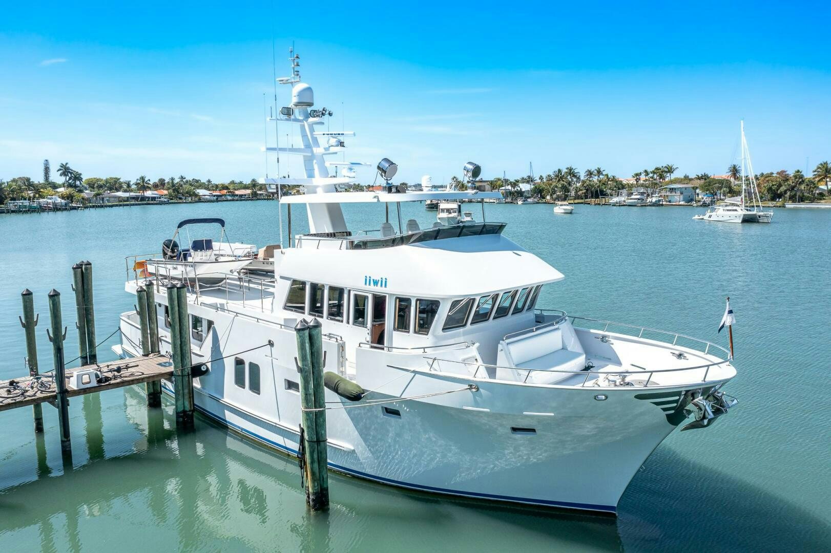 a boat docked at a pier aboard IIWII Yacht for Sale