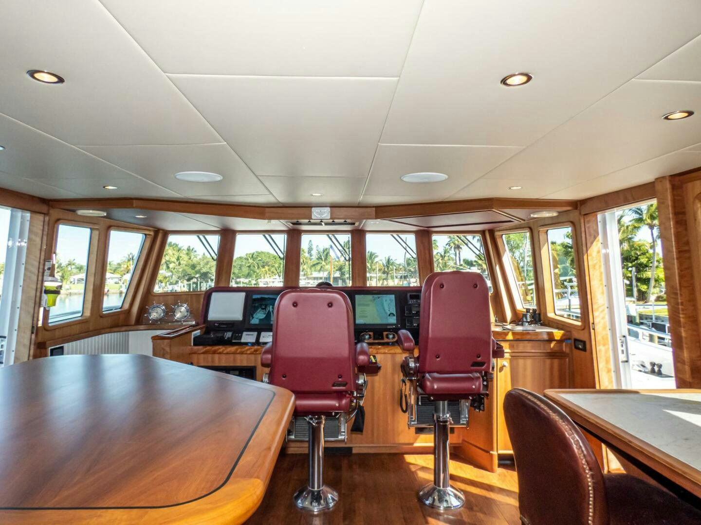 a room with a table chairs and a large window aboard IIWII Yacht for Sale