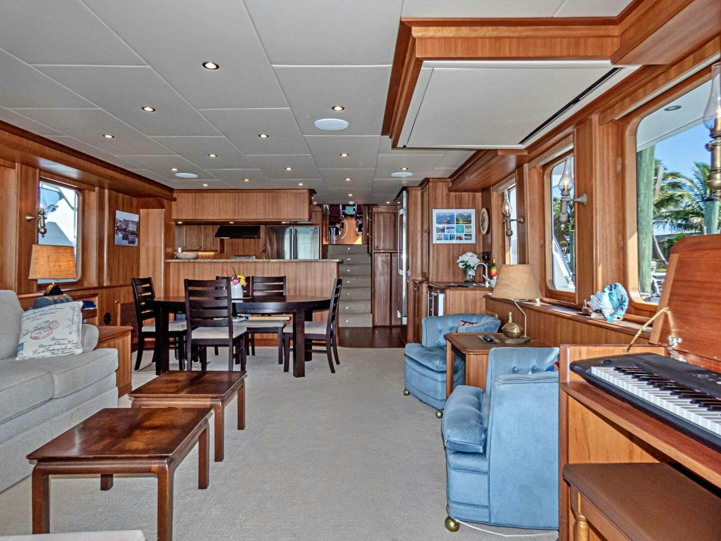 a living room with a piano aboard IIWII Yacht for Sale