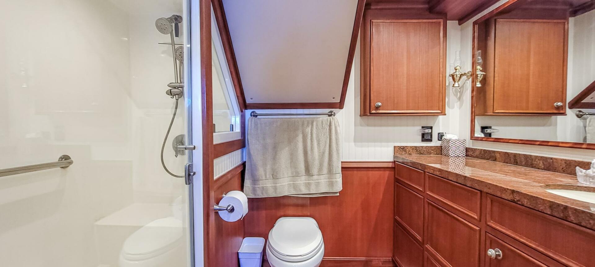 a bathroom with a toilet and a sink aboard IIWII Yacht for Sale
