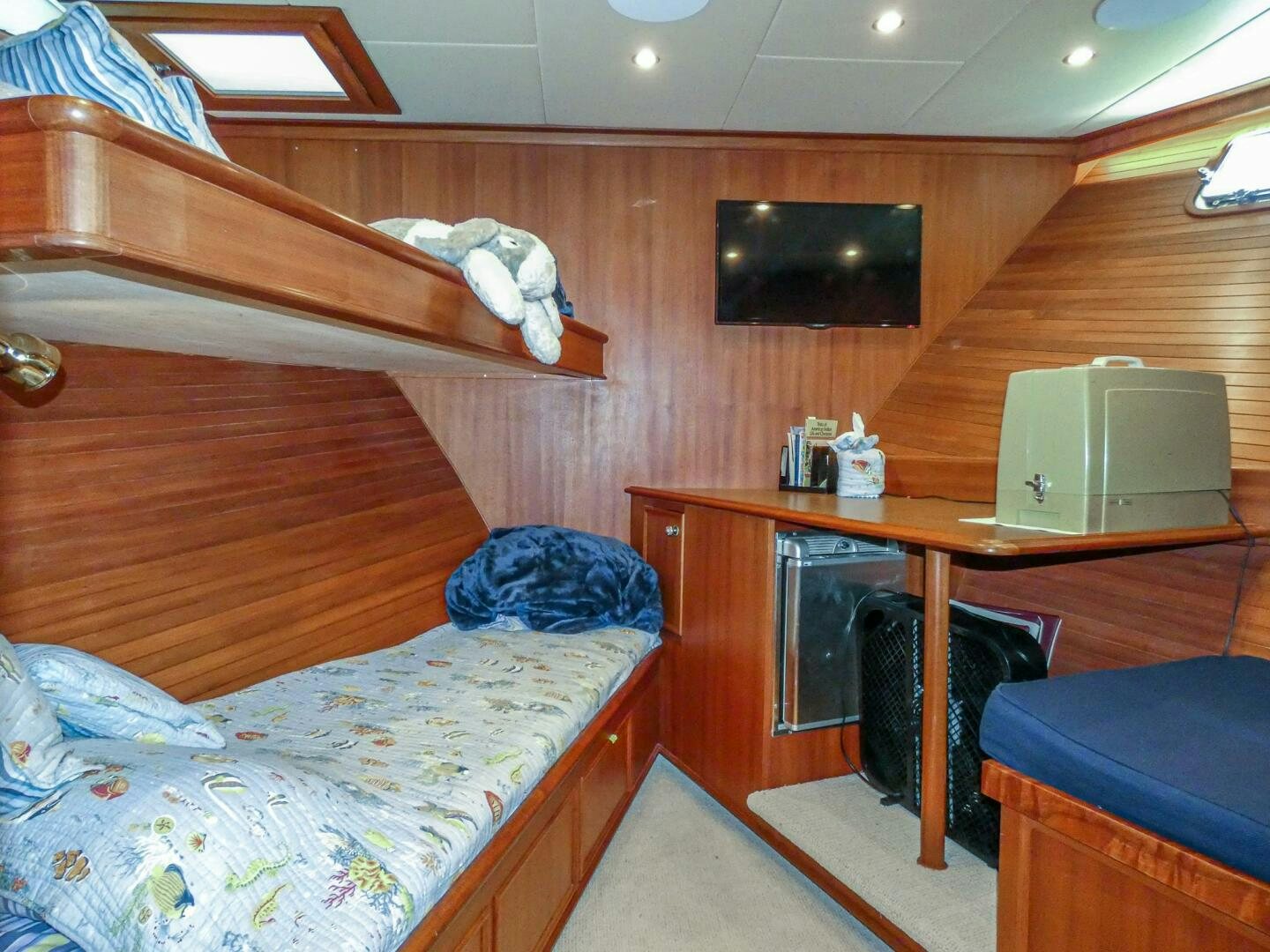 a room with a bed and a television aboard IIWII Yacht for Sale