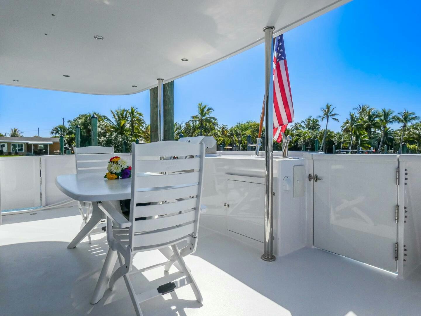 a white chair next to a table aboard IIWII Yacht for Sale