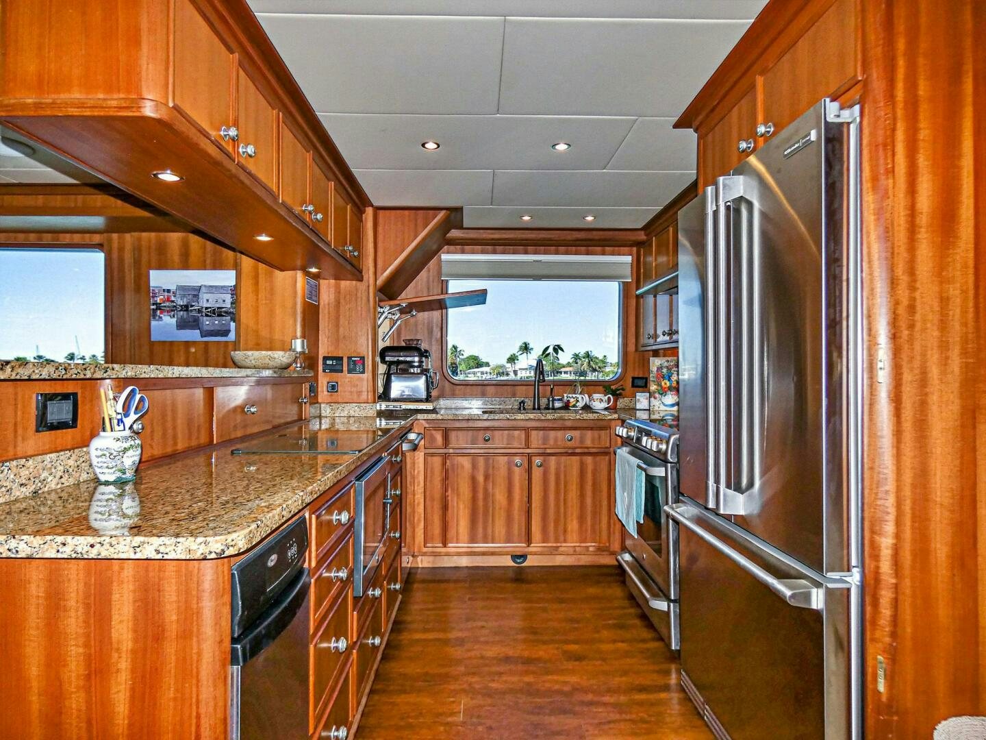 a kitchen with wooden cabinets aboard IIWII Yacht for Sale