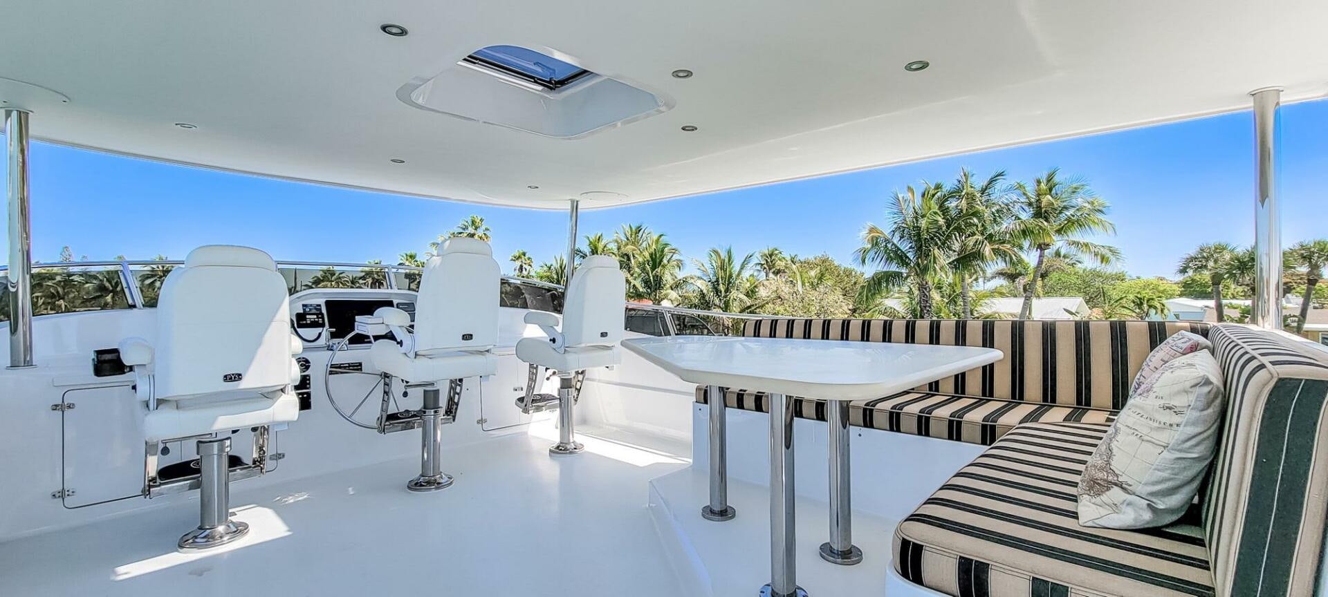 a pool with chairs and tables aboard IIWII Yacht for Sale
