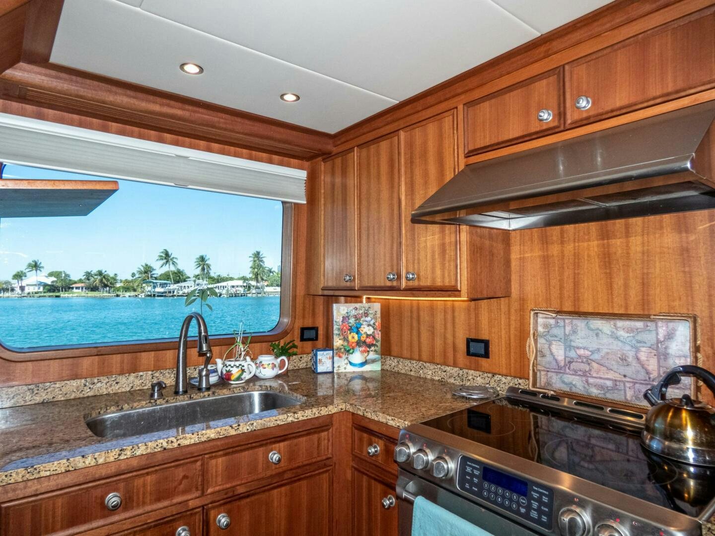a kitchen with wooden cabinets aboard IIWII Yacht for Sale