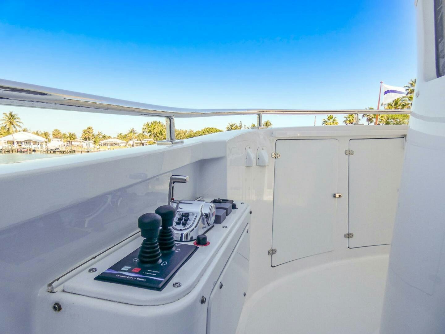 a white kitchen with a large window aboard IIWII Yacht for Sale
