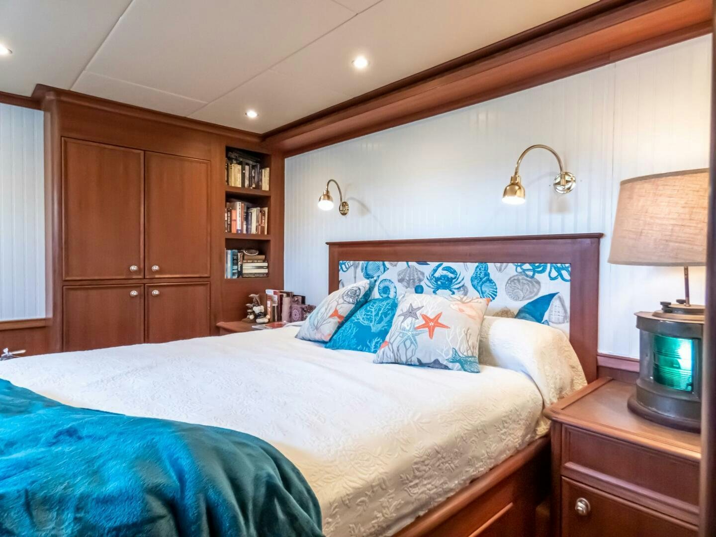 a bedroom with a bed and a television aboard IIWII Yacht for Sale