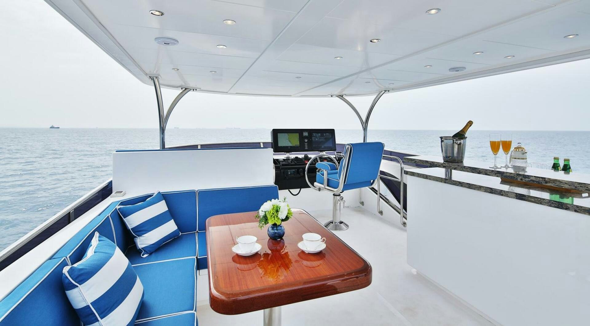 a boat with a table and chairs aboard DEESCOVERY Yacht for Sale