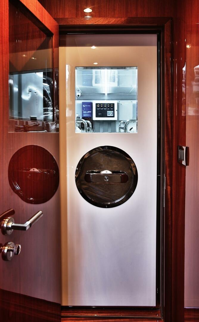 a door with a round window aboard DEESCOVERY Yacht for Sale