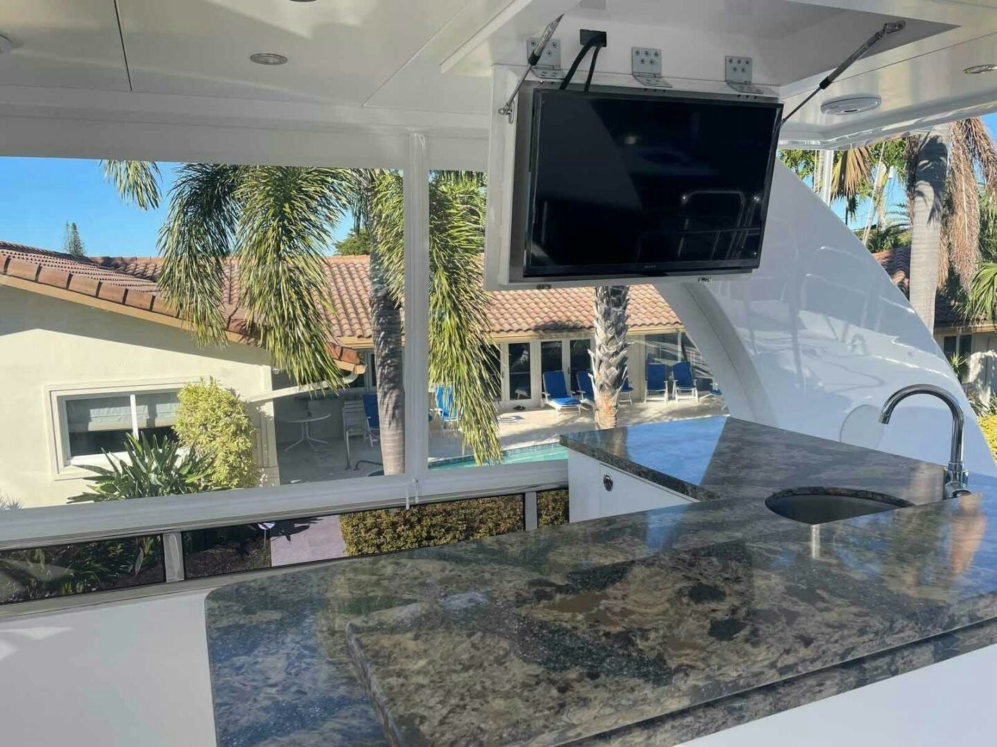 a large outdoor tv on a car aboard DEESCOVERY Yacht for Sale