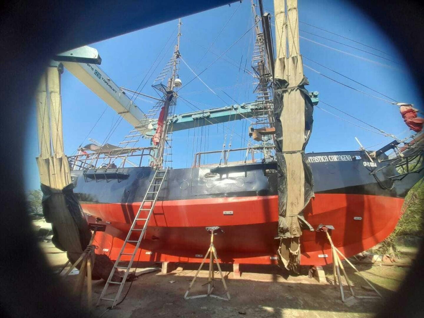 a person standing next to a boat aboard LA FANTASTICA Yacht for Sale
